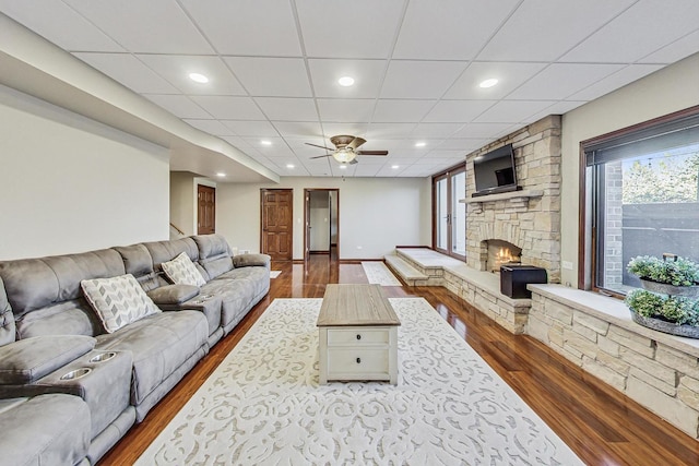 living room featuring a drop ceiling and hardwood / wood-style floors