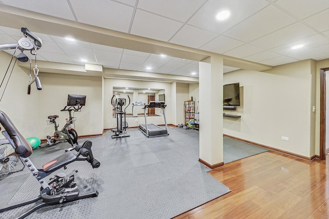 workout room with wood-type flooring and a drop ceiling