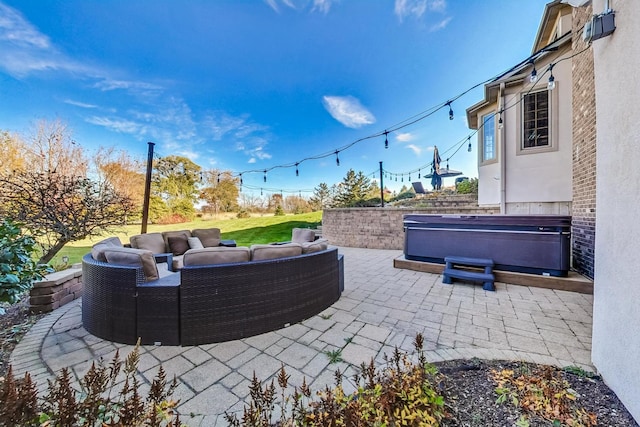 view of patio with a hot tub and an outdoor hangout area