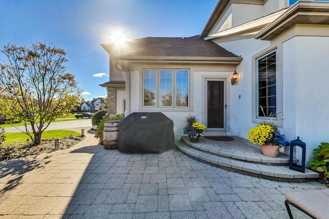 property entrance featuring a patio area