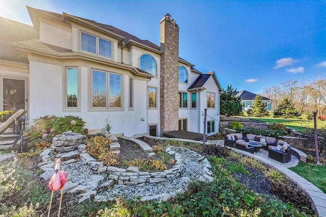 back of property with an outdoor living space