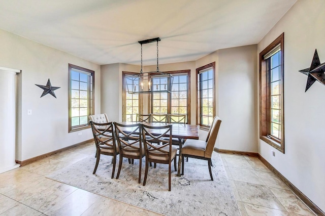 dining room with plenty of natural light and a notable chandelier