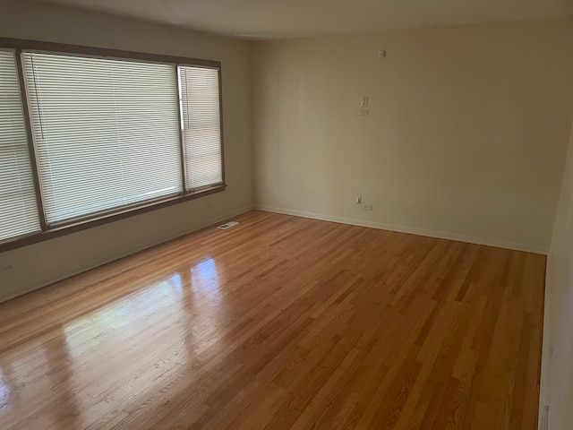 unfurnished room with light wood-type flooring