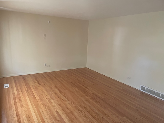 unfurnished room with light wood-type flooring