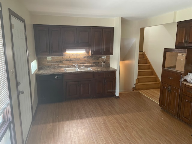 kitchen featuring light hardwood / wood-style floors, dark brown cabinetry, sink, and backsplash