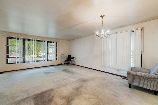 unfurnished living room with an inviting chandelier and carpet flooring