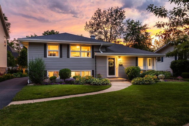 tri-level home featuring a yard