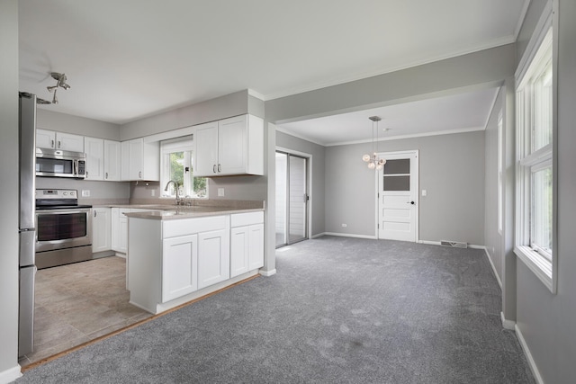 kitchen with stainless steel appliances, sink, crown molding, light colored carpet, and white cabinetry