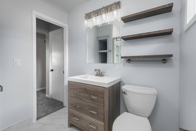 bathroom featuring vanity and toilet