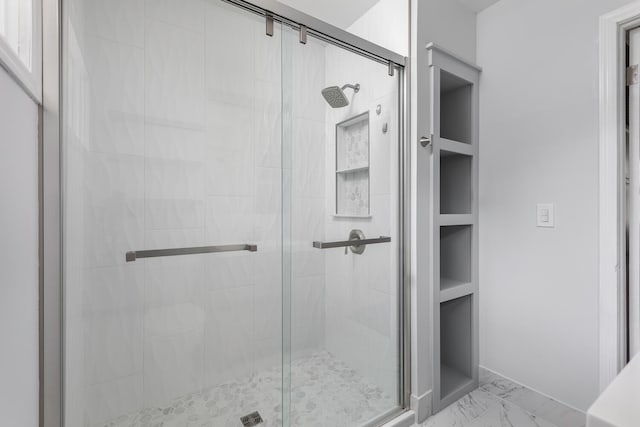 bathroom featuring an enclosed shower and built in features