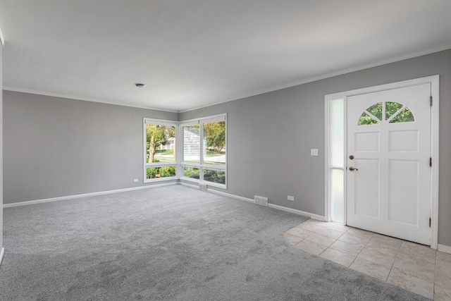 entryway featuring crown molding and light colored carpet