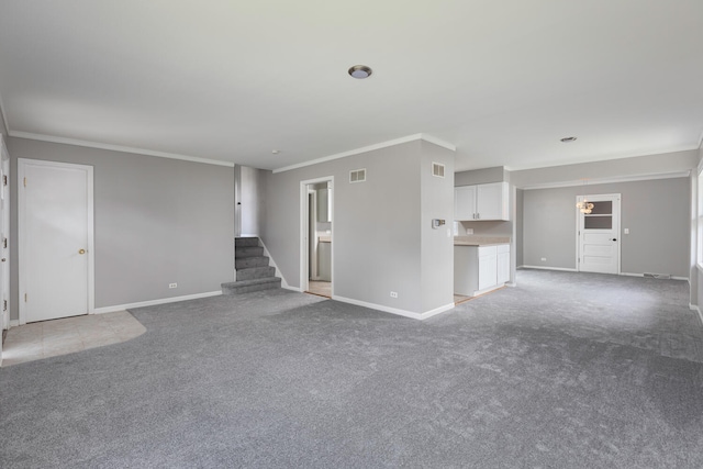 unfurnished living room featuring crown molding and carpet floors