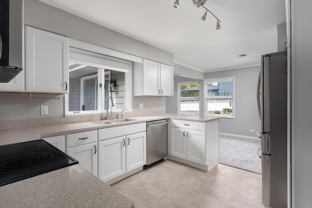 kitchen featuring white cabinetry, appliances with stainless steel finishes, sink, and ornamental molding