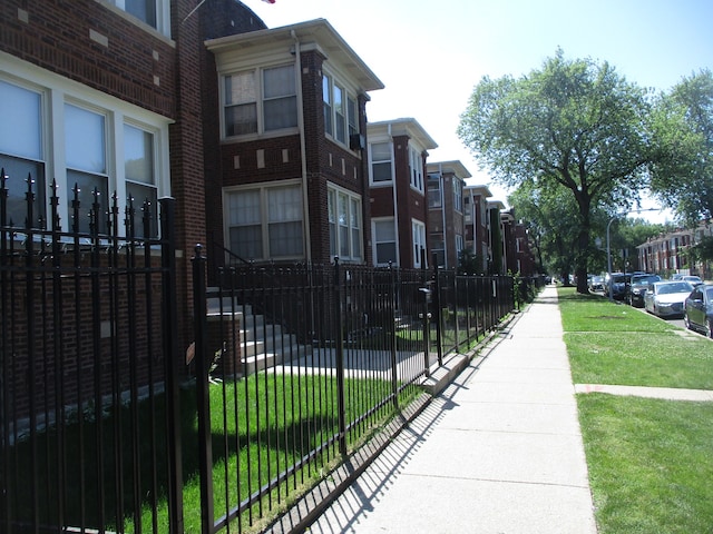 view of home's community featuring a lawn