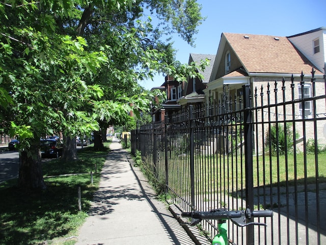 view of gate with a yard