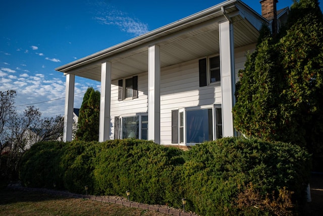 4140 E German Valley Rd, Freeport, IL 61032 - view of side of property with a chimney and covered porch
