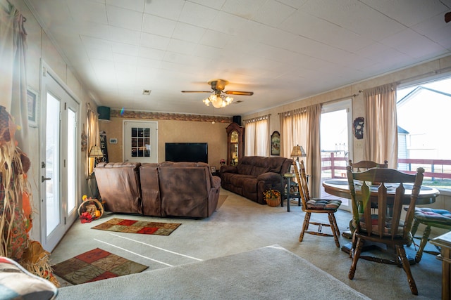 living room featuring ceiling fan and carpet