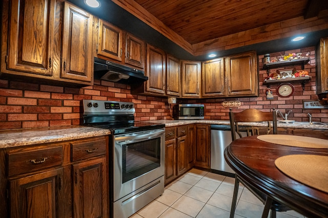 kitchen with appliances with stainless steel finishes, light tile patterned floors, light stone counters, and wooden ceiling