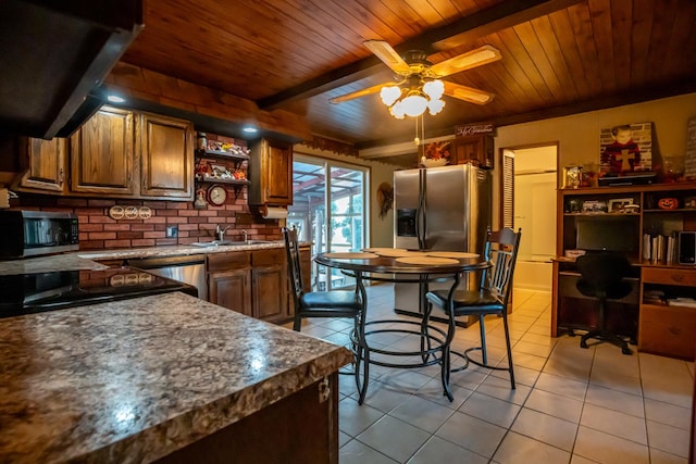 4140 E German Valley Rd, Freeport, IL 61032 - kitchen with stainless steel appliances, light tile patterned flooring, under cabinet range hood, ceiling fan, and a sink
