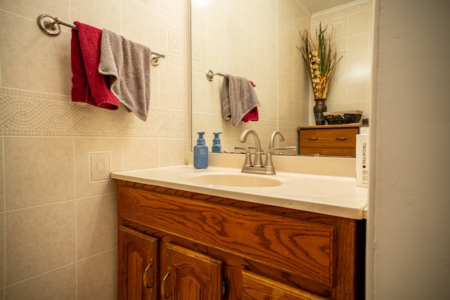 bathroom featuring vanity and tile walls