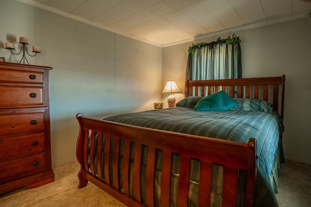 carpeted bedroom with ornamental molding