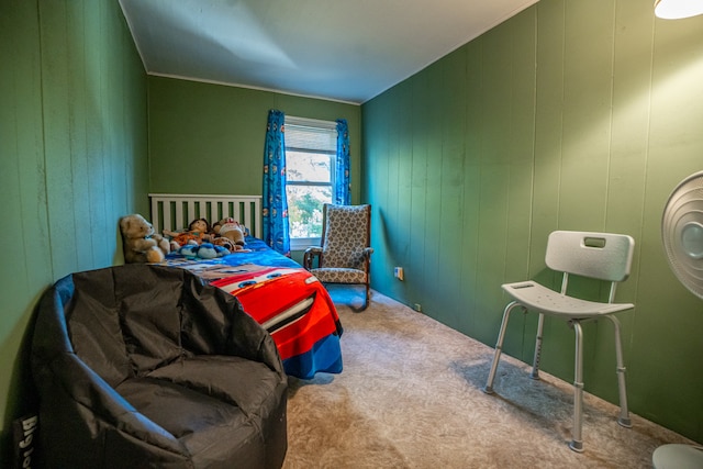 bedroom featuring carpet flooring and wood walls