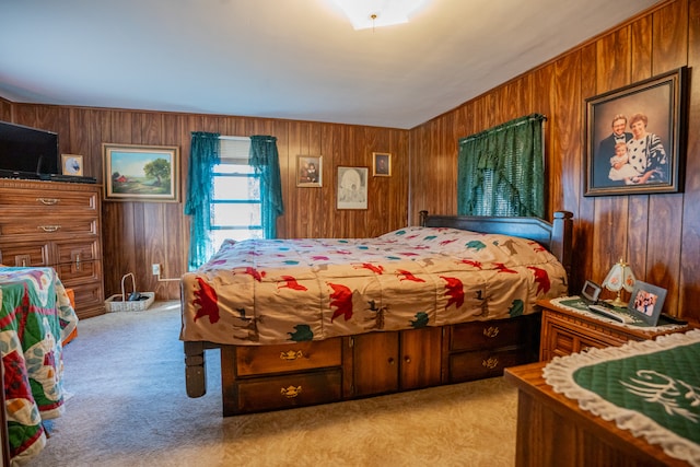 bedroom with wood walls and light carpet