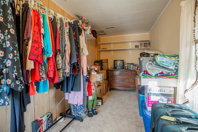 walk in closet featuring light colored carpet