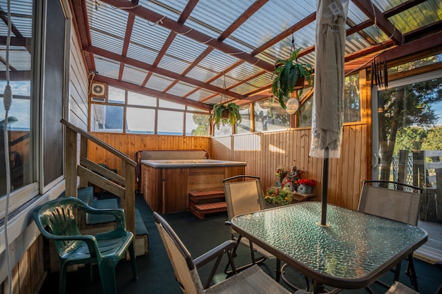 sunroom with a jacuzzi and vaulted ceiling