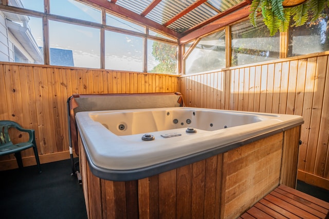 interior space featuring a hot tub, plenty of natural light, and vaulted ceiling