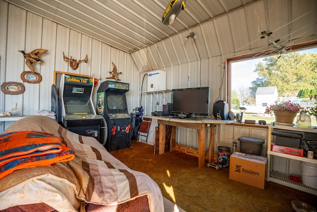 garage featuring wooden walls and ceiling fan