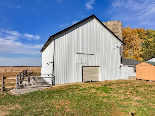 view of outdoor structure with a yard and a rural view