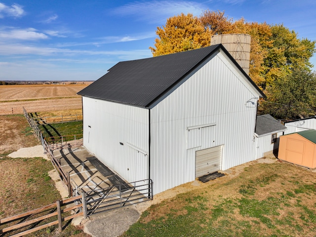 view of outdoor structure with a rural view