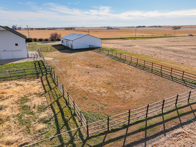 view of yard with an outbuilding and a rural view