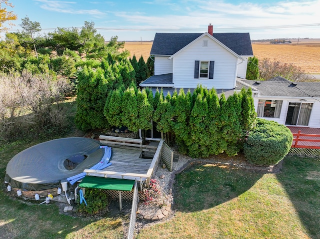 rear view of property featuring a lawn