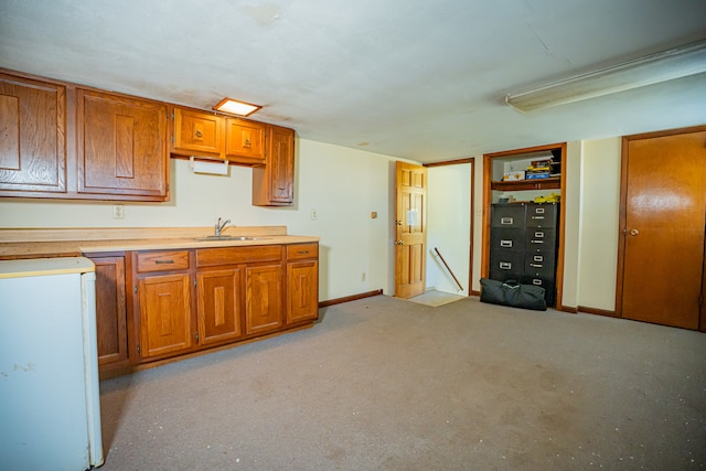 kitchen featuring white refrigerator and sink