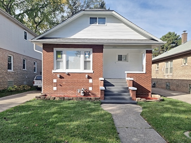 bungalow featuring a front yard and central AC