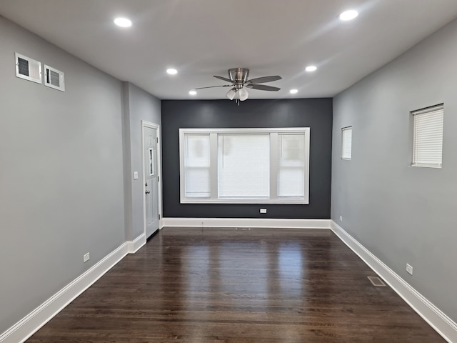 unfurnished room featuring dark wood-type flooring and ceiling fan