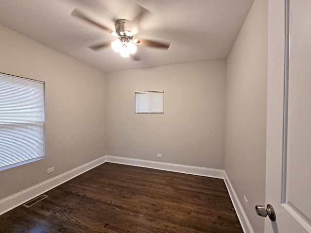 empty room with dark wood-type flooring and ceiling fan