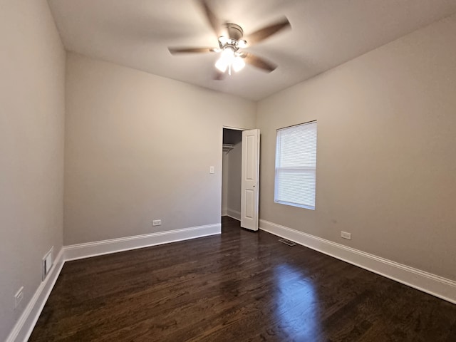 unfurnished bedroom with dark hardwood / wood-style floors, a closet, and ceiling fan