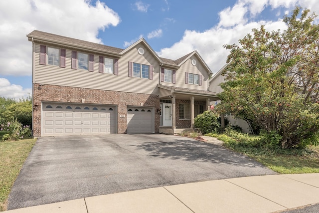 view of front of property with driveway, brick siding, a porch, and an attached garage