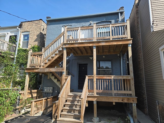 rear view of property featuring a wooden deck