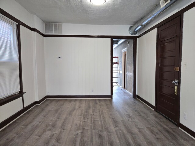 spare room with hardwood / wood-style flooring and a textured ceiling