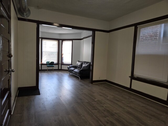 unfurnished room with dark hardwood / wood-style floors