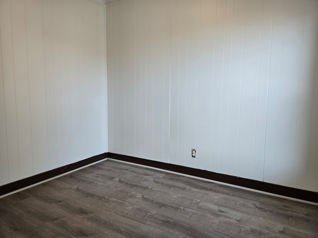 unfurnished room with wood-type flooring