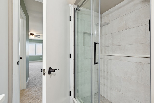 bathroom featuring walk in shower and ceiling fan