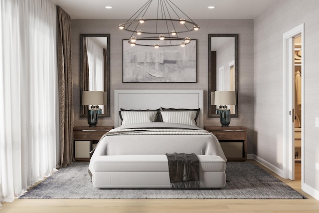 bedroom featuring hardwood / wood-style floors and an inviting chandelier