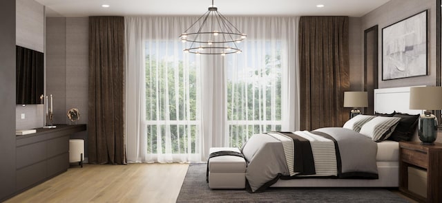 bedroom featuring an inviting chandelier, light wood-type flooring, and multiple windows