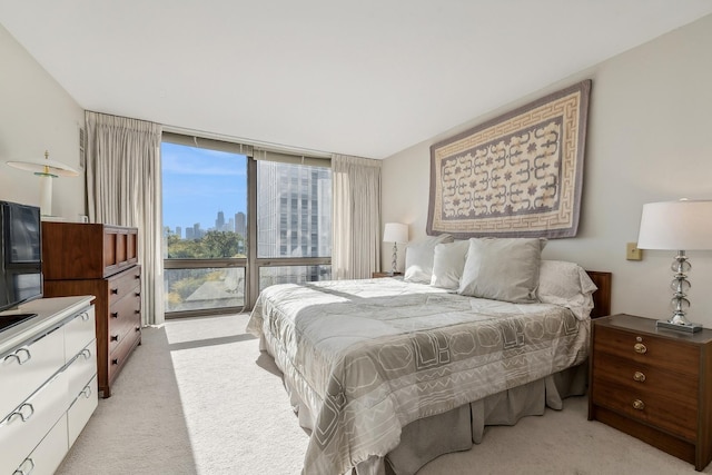 bedroom featuring light carpet and expansive windows