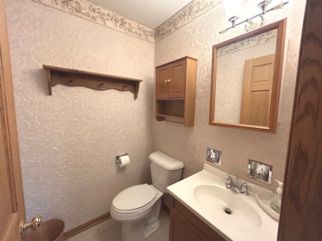 bathroom with tile patterned flooring, vanity, and toilet